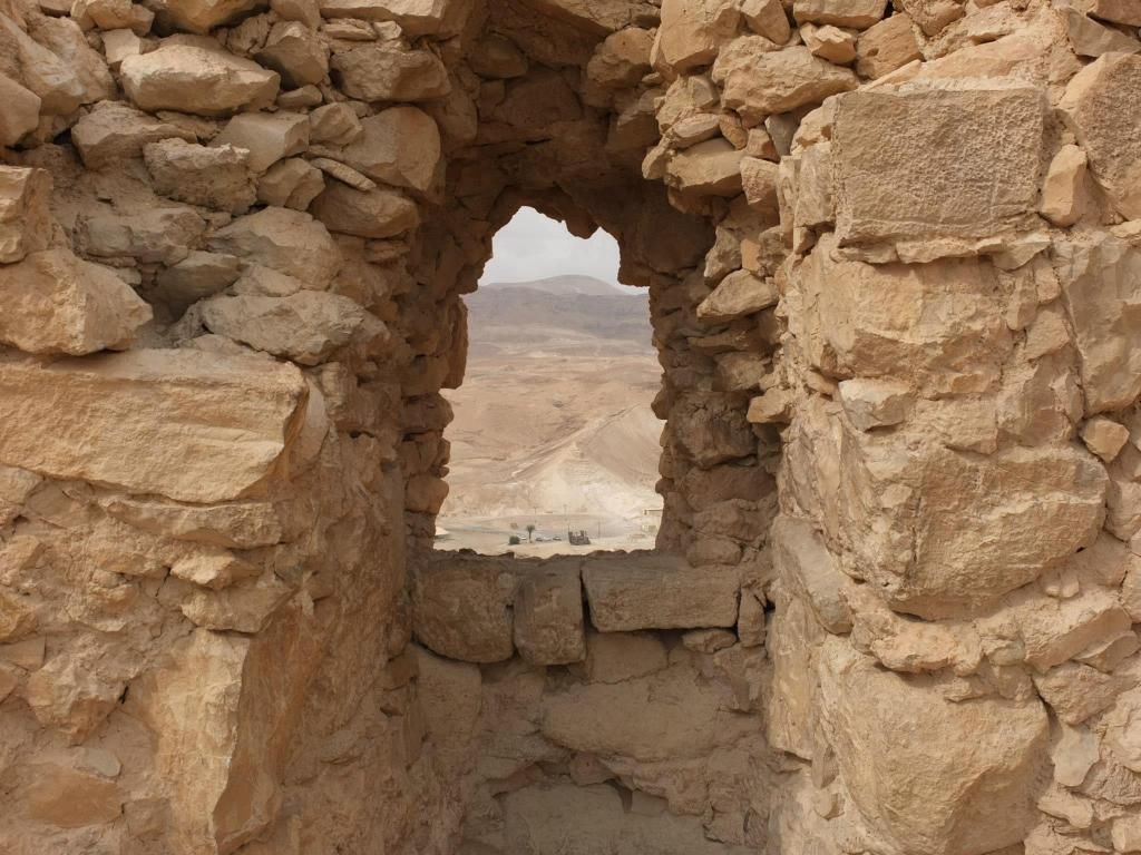 a stone arch in a desert