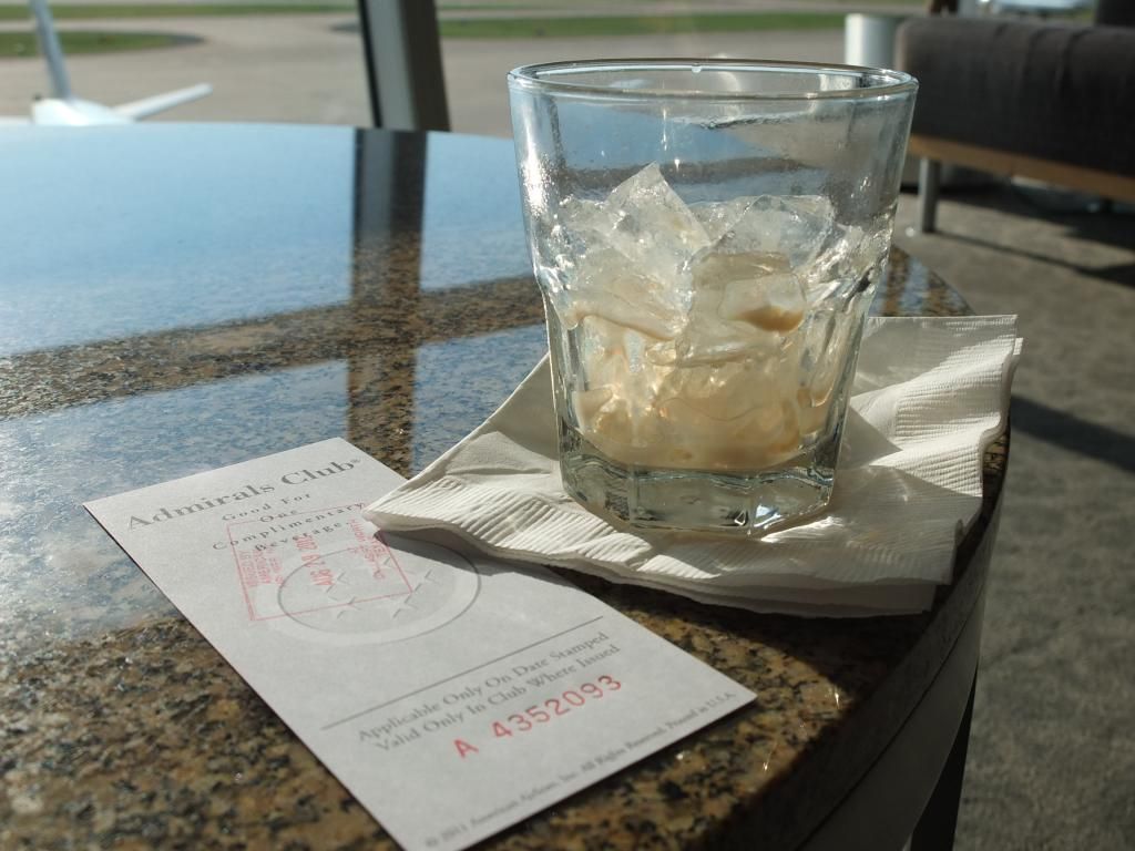 a glass with ice on a napkin on a table